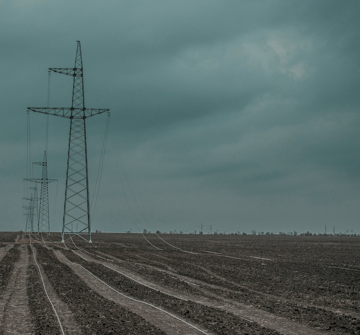 gray metal electricity tower under blue sky