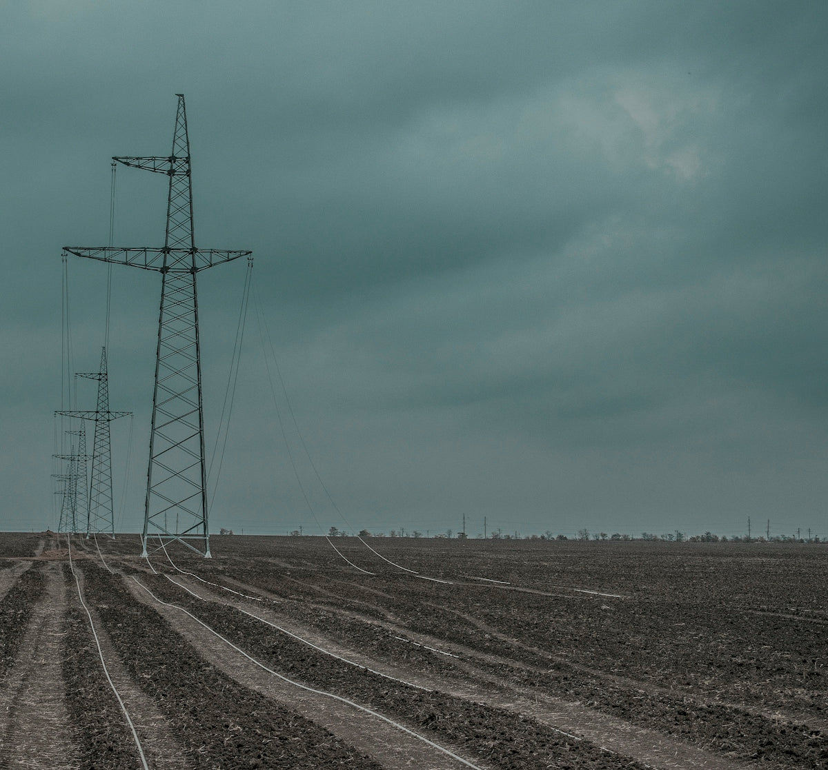 gray metal electricity tower under blue sky