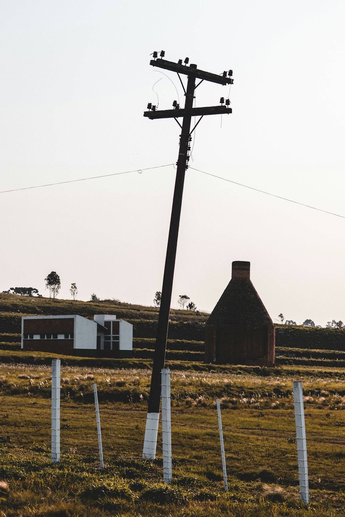 brown wooden house near brown wooden fence during daytime
