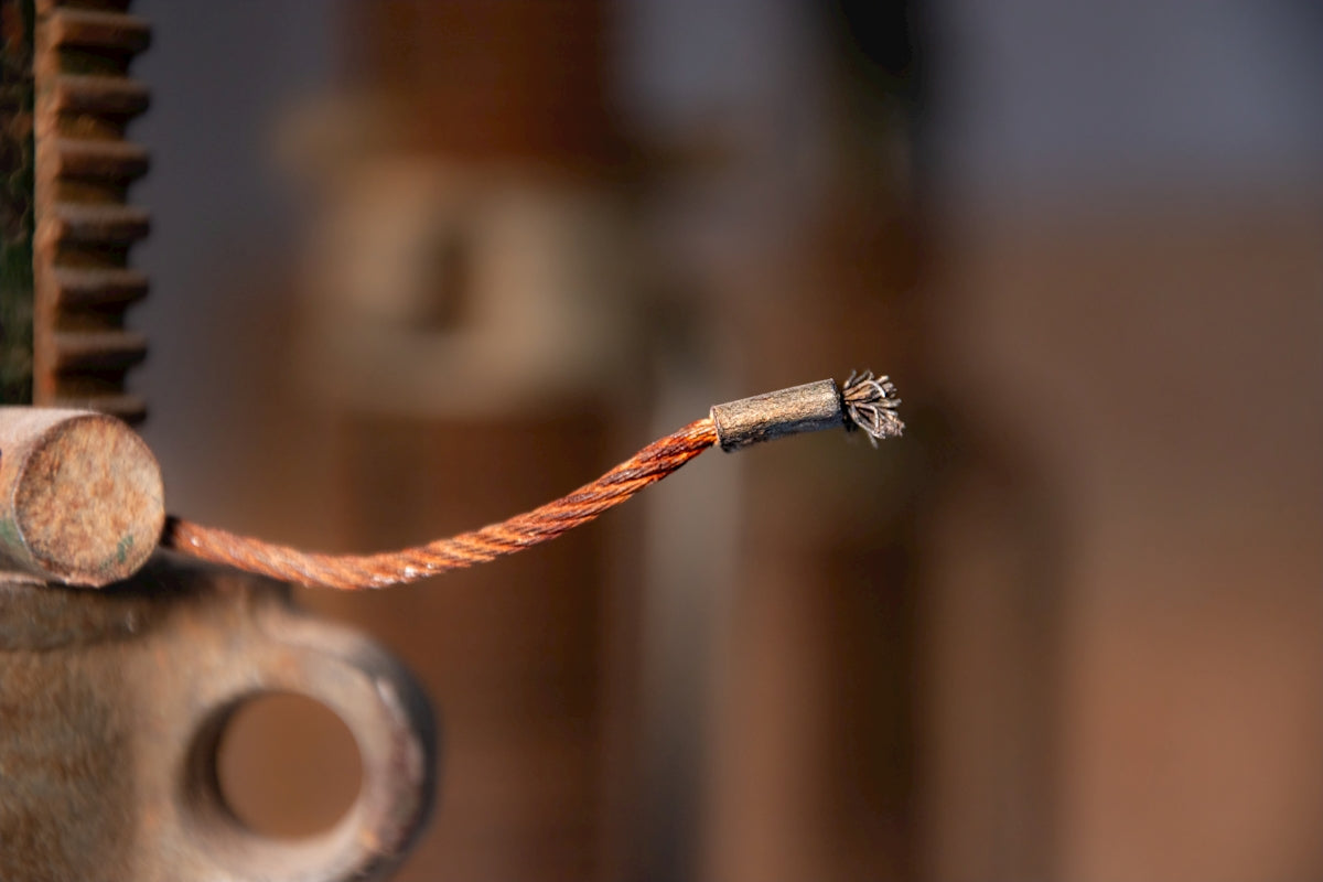 a close up of a piece of metal with a wire attached to it