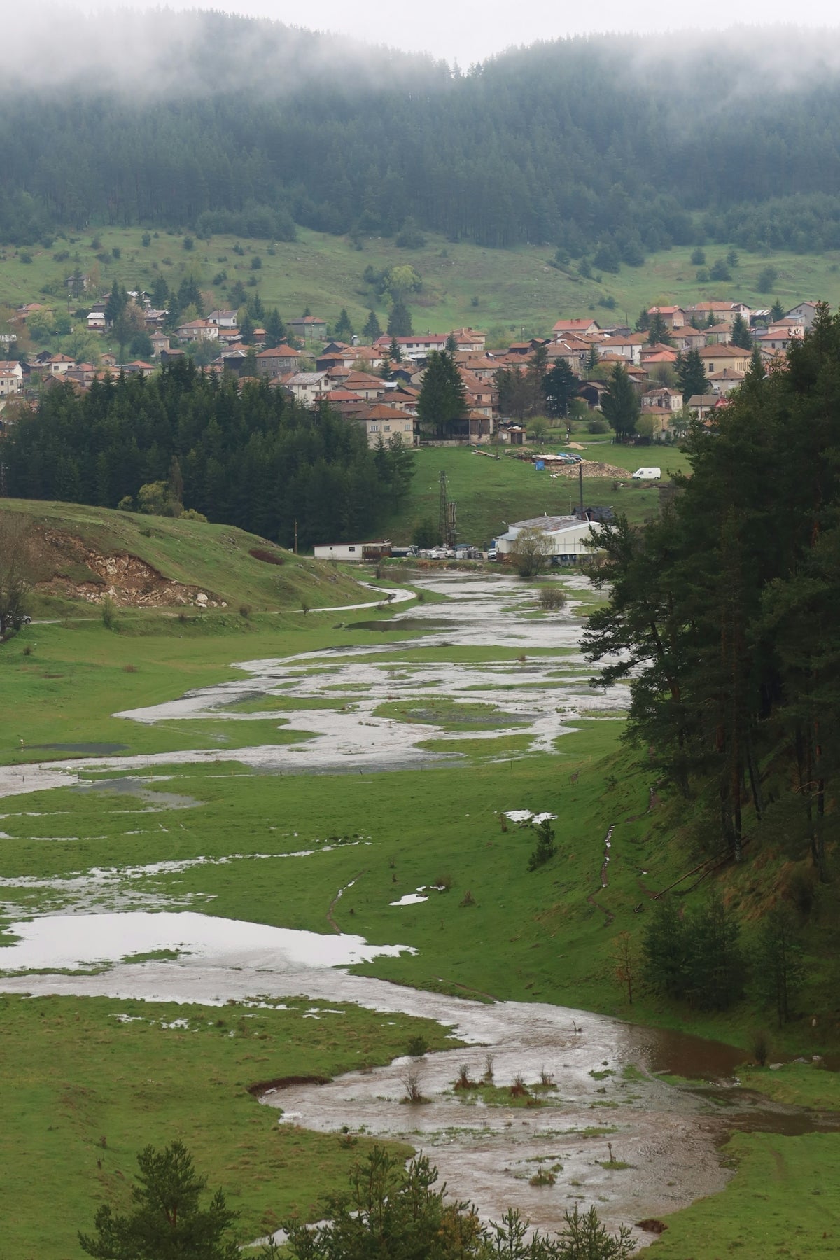 a river running through a lush green countryside
