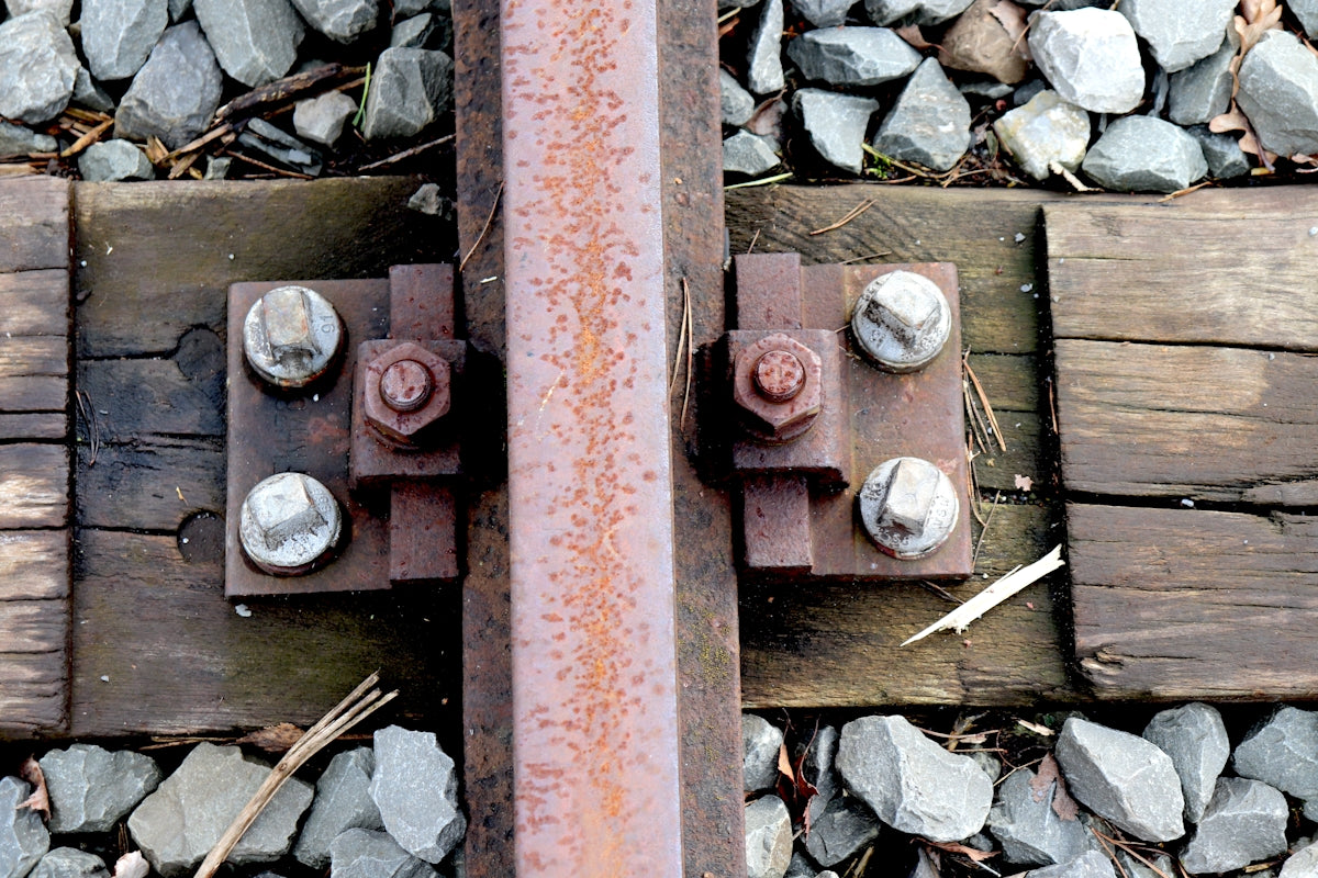 A close up of a train track with rocks