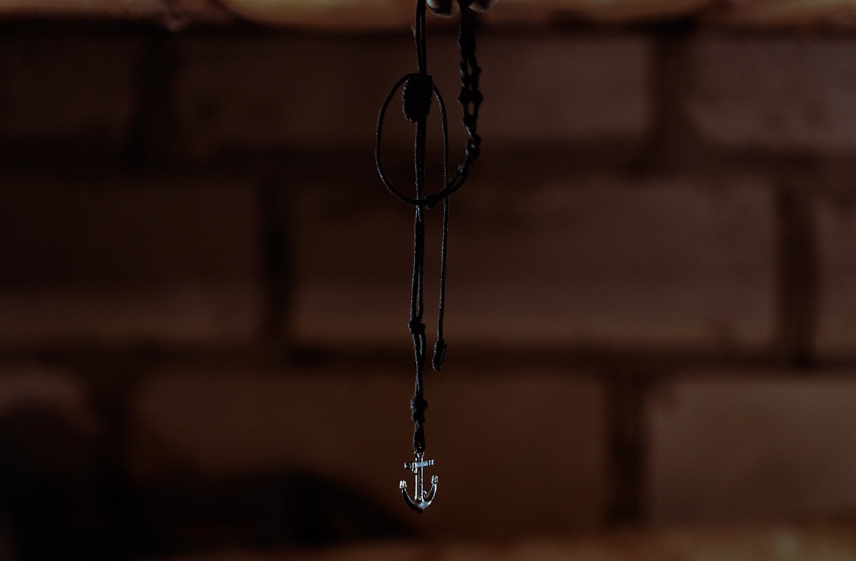 Close-up of a pendant hanging against brick wall
